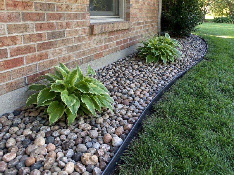 River-rock planting bed with a clean metal landscape border