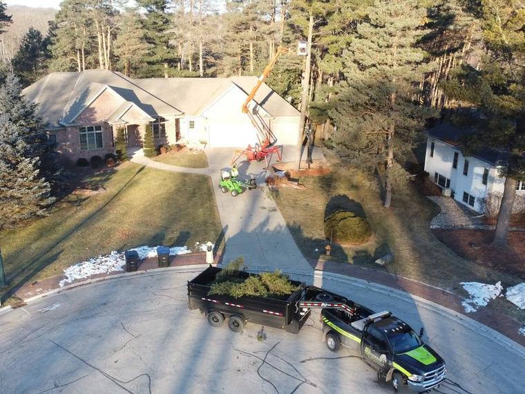 Drone view of a Two Guys USA truck and trailer loading tree limbs